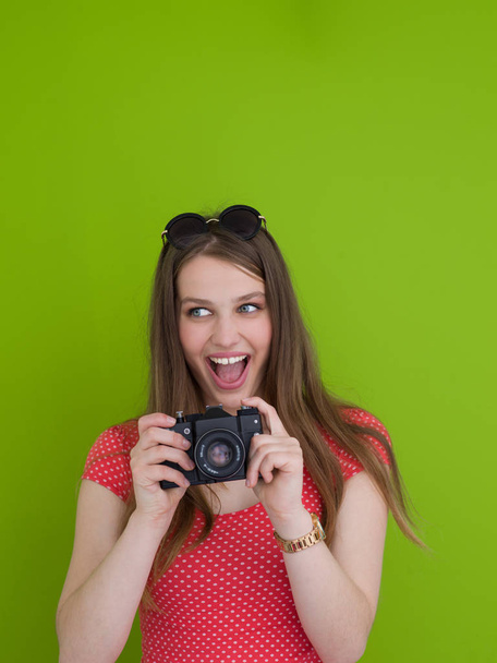 smilling girl taking photo on a retro camera - Фото, изображение