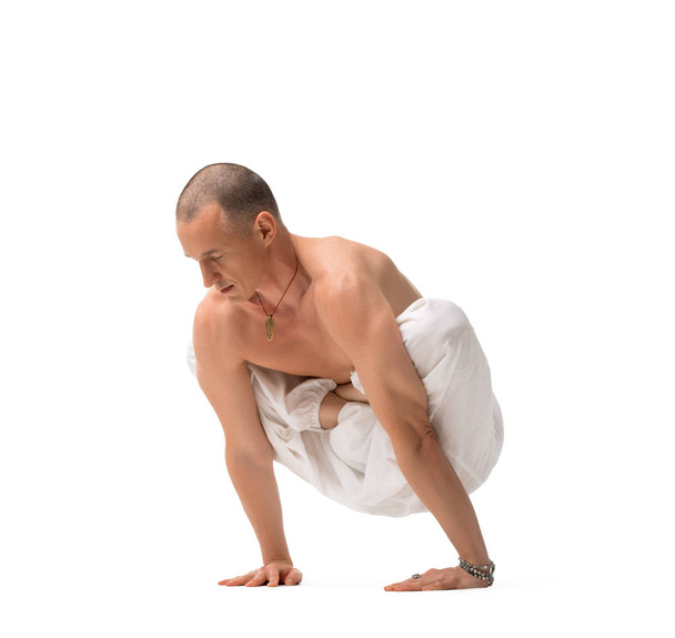 Mature shirtless handsome man doing yoga - Valokuva, kuva