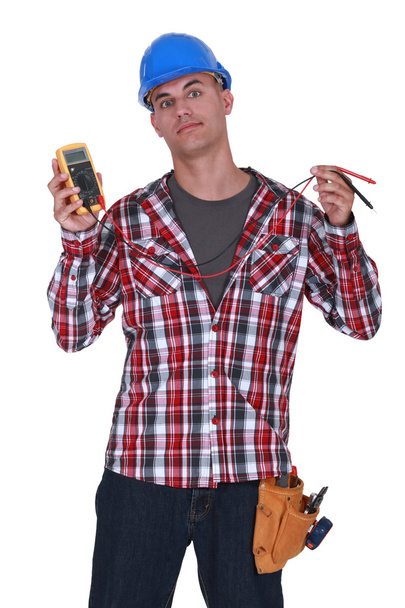 Electrician holding a measurement tool - Photo, image