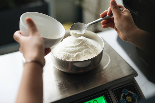 Bakery chef weighing flour on the digital scale - Fotoğraf, Görsel