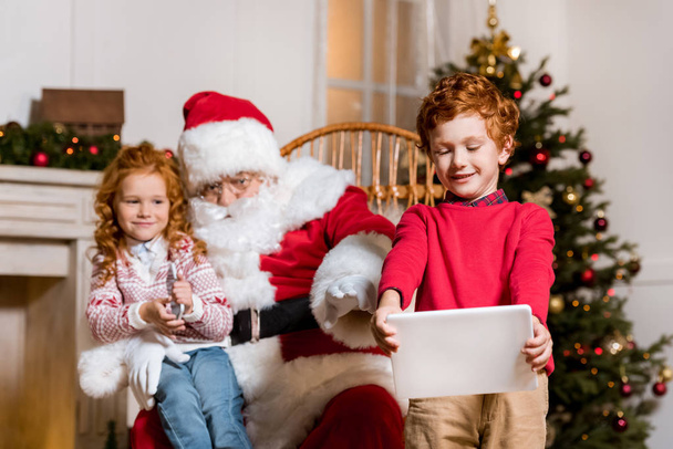 santa claus and children with digital devices - Foto, Imagem
