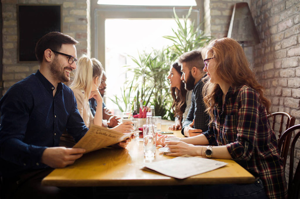 Happy colleagues from work socializing in restaurant - Foto, Bild
