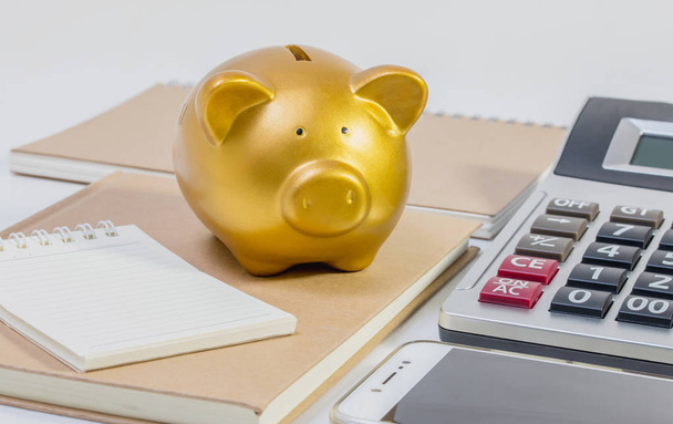 Pig piggy bank, calculator, phone, notebook, pen, glasses - Фото, изображение