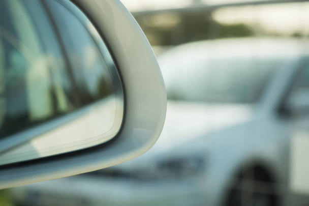 Looking into the outside mirror of a car with soft bokeh - Фото, зображення
