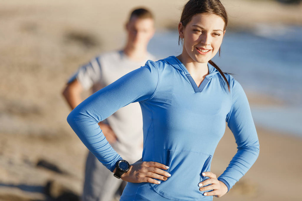 Young couple on beach training together - Foto, Imagen