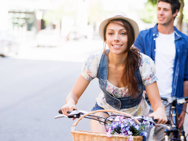 Beautiful woman riding on bike - Фото, изображение