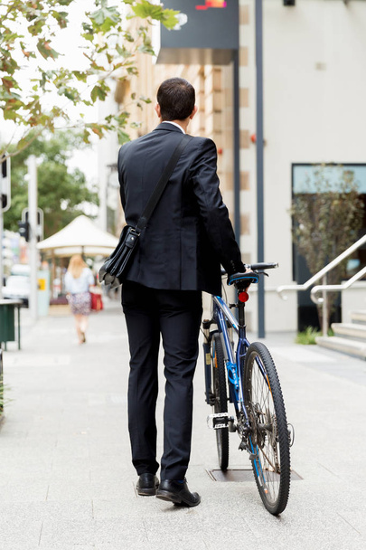 Young businessmen with a bike - Фото, зображення