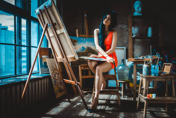 Woman painting in her studio - Фото, изображение