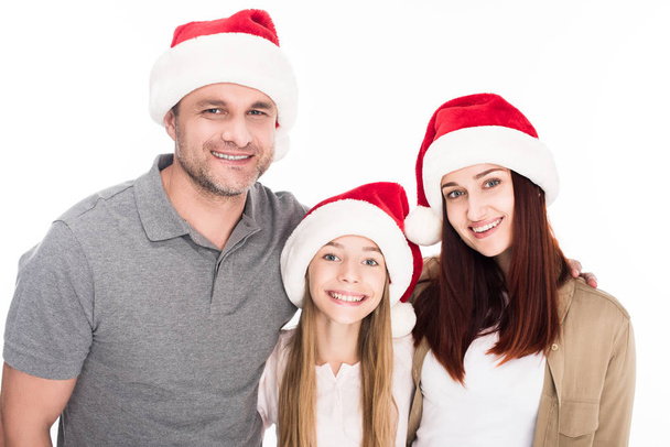 family in santa hats - Фото, изображение