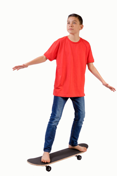 Young teenage caucasian boy with his skateboard - Fotografie, Obrázek