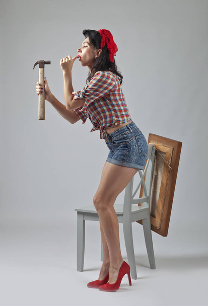 Girl with hammer .  - Foto, Bild