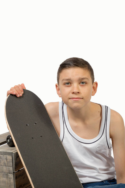 Young teenage caucasian boy with his skateboard - 写真・画像