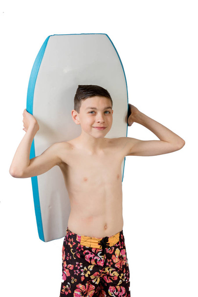 Young teenage caucasian boy with his body board - Foto, imagen