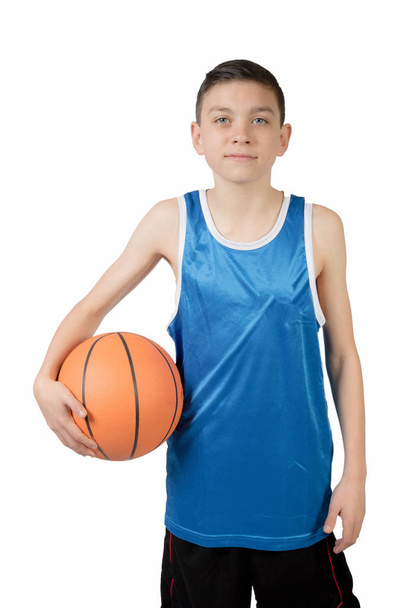 Young caucasian teenage boy with a basketball - 写真・画像