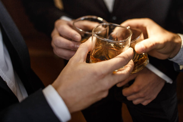 groom and his groomsmen drinking whiskey - 写真・画像