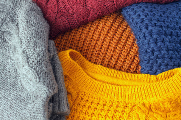 Concept knitted wool colorful warm sweaters closeup - Foto, imagen