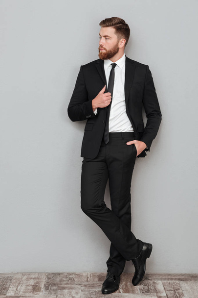 Stylish handsome businessman in suit posing while standing - Fotoğraf, Görsel