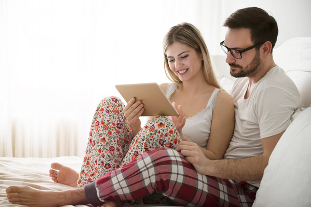 Attractive couple in love using digital tablet - Zdjęcie, obraz