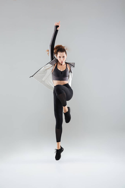 Full length portrait of a young fitness woman in sportswear - Фото, зображення