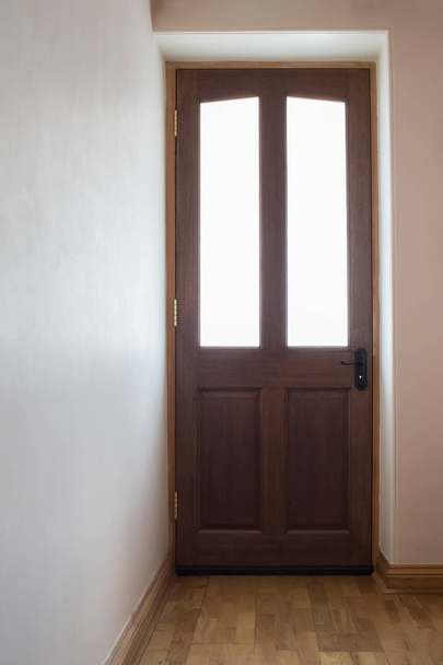 Porte avant en bois à la maison avec la lumière à travers les fenêtres
 - Photo, image