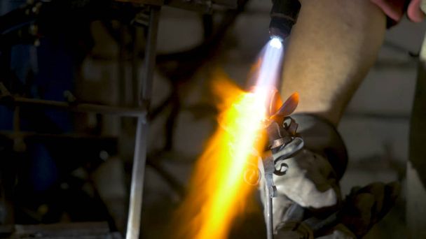 Blacksmith makes an iron rose. Man makes a rose out of iron - Photo, Image