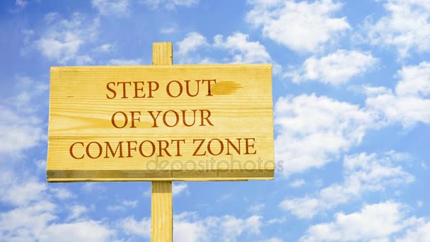 Step out of your comfort zone. Words on a wooden sign against time lapse clouds in the blue sky.  - Footage, Video