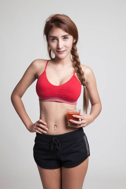 Beautiful healthy Asian girl with tomato juice. - Zdjęcie, obraz