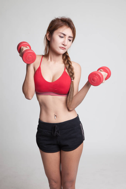 Tired Asian healthy girl exercise with dumbbell. - Valokuva, kuva