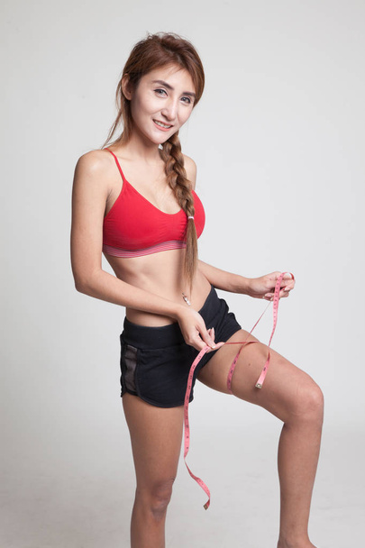 Beautiful Asian healthy girl  measuring her leg. - Φωτογραφία, εικόνα