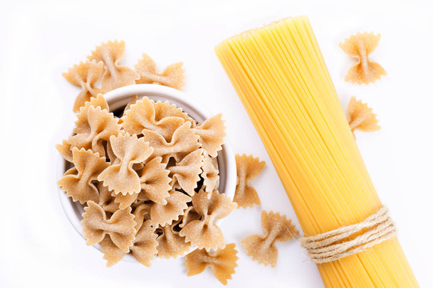 Organic Farfalle pasta and Spaghetti isolated on white - Photo, Image