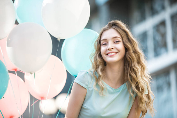 beautiful woman with flying multicolored balloons - Fotoğraf, Görsel