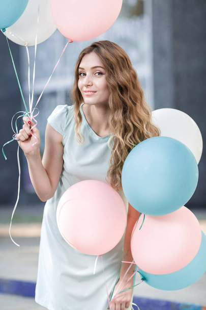 beautiful woman with flying multicolored balloons - Photo, image
