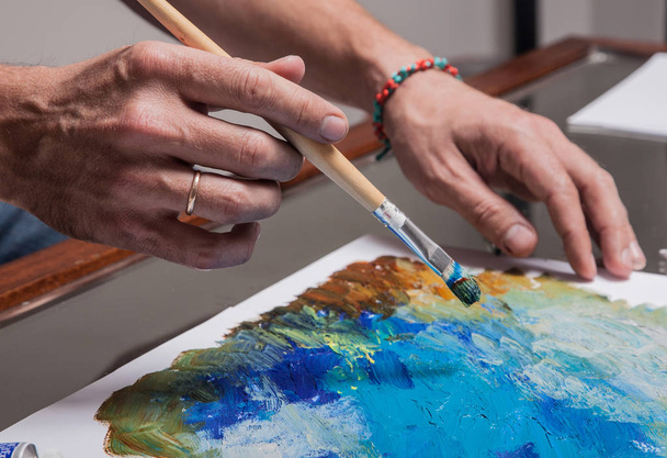 Artist's hand with a brush - Фото, изображение