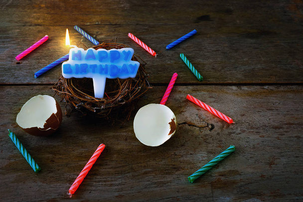 Shattered Eggshell With Nest and Candle for Happy Birthday Conce - 写真・画像