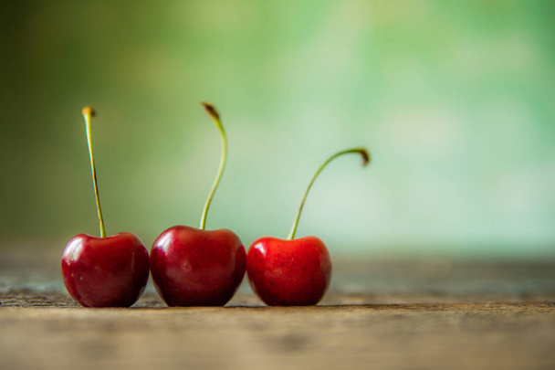 Cherry on wooden board. Tree cherries, selective focus - Φωτογραφία, εικόνα