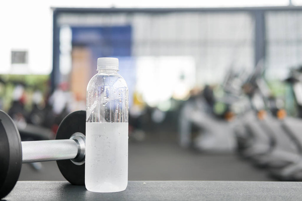 dumbbell, drinking water in gym or health club. sport, fitness l - Φωτογραφία, εικόνα