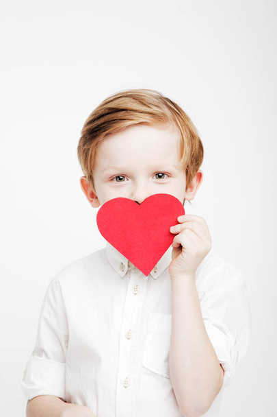 cute little boy with a red heart in the hands - Foto, imagen