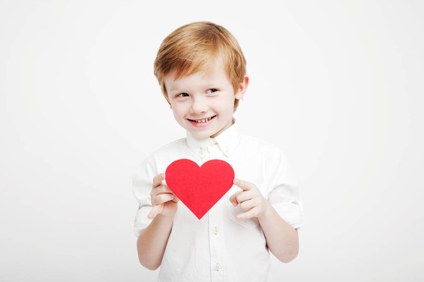 cute little boy with a red heart in the hands - Fotó, kép
