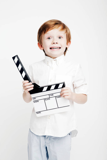 Little cute emotional boy with cinema clapper - Foto, afbeelding