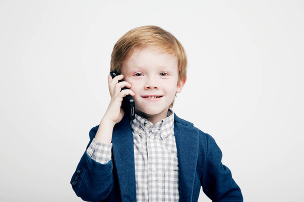Cute little boy emotionally talking on the phone - Фото, зображення