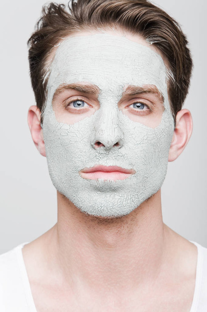 Young handsome man in facial mask - 写真・画像