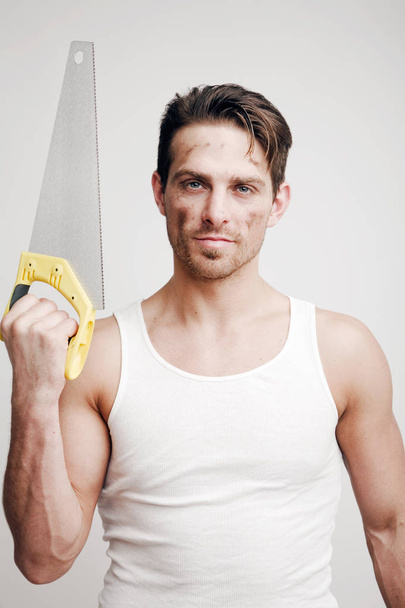 Portrait of a man with a handsaw - Foto, afbeelding