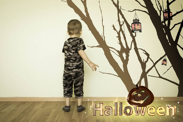 Halloween. the boy draws on the wall - Fotó, kép
