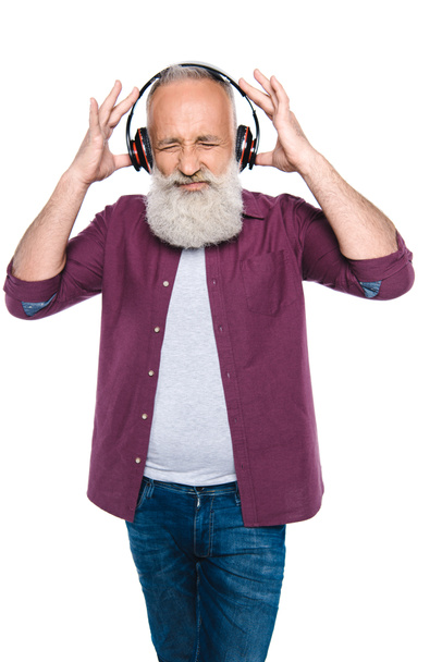 senior man listening music with headphones - Фото, изображение
