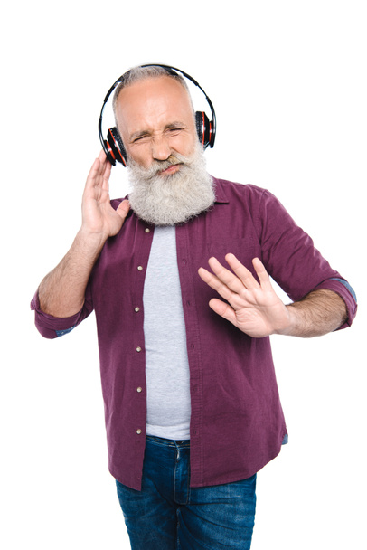 senior man listening music with headphones - Foto, Imagen