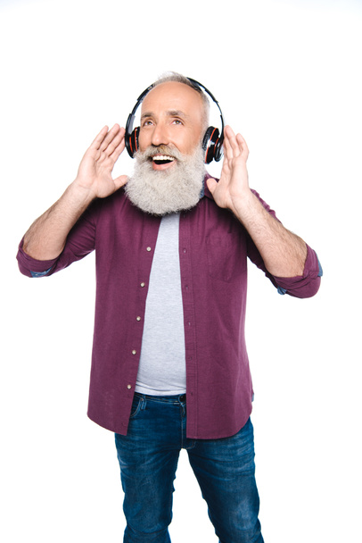 senior man listening music with headphones - Fotografie, Obrázek