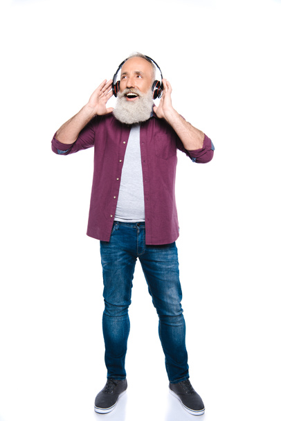 senior man listening music with headphones - Foto, afbeelding