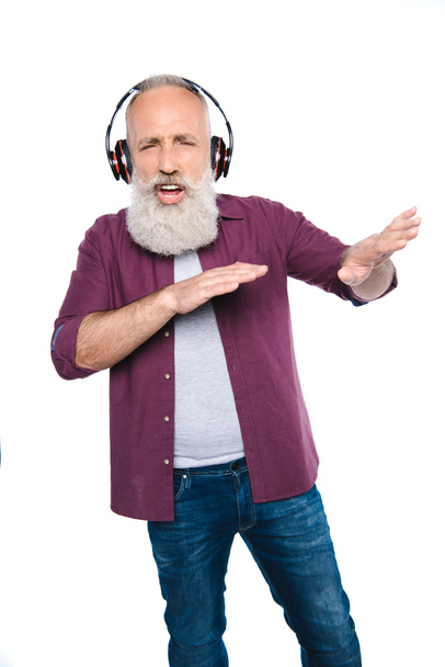 senior man dancing and singing with headphones - 写真・画像