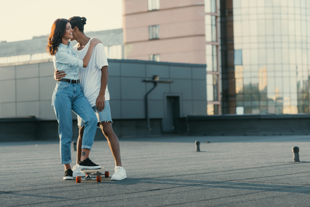 couple embracing on rooftop - Photo, Image