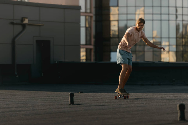man riding on skateboard on rooftop - Photo, image